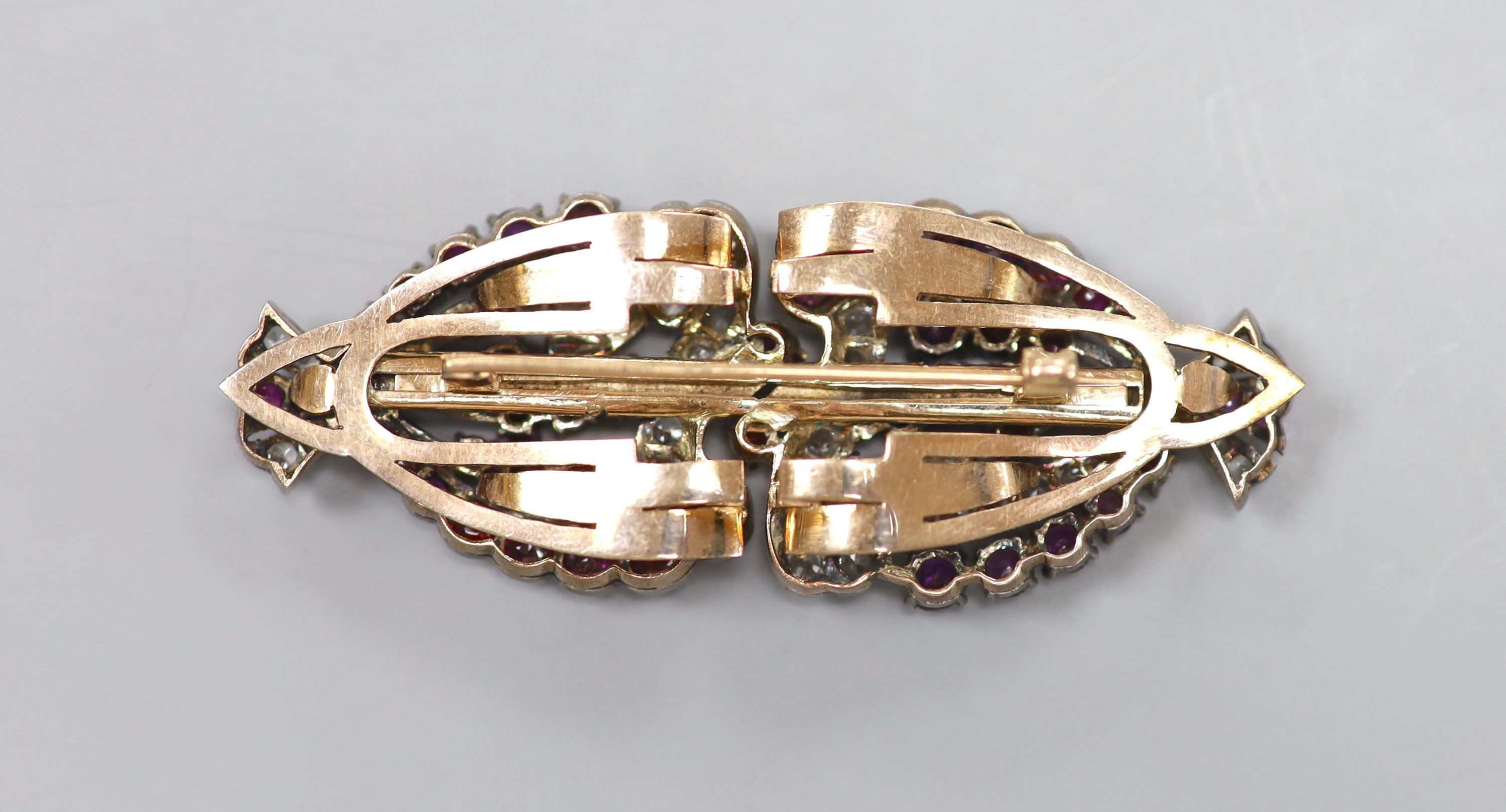 An early 20th century yellow metal and two colour paste set double clip brooch, 7cm